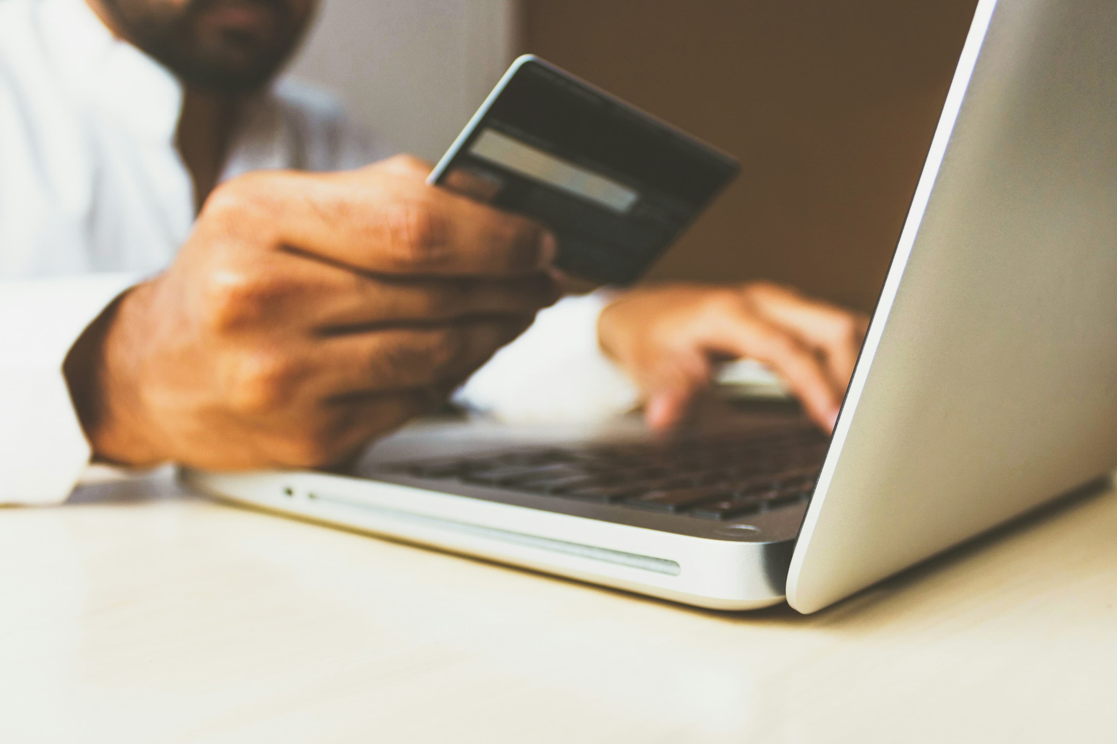 Person researching products on a laptop for their Shopify dropshipping store with analytics visible on screen